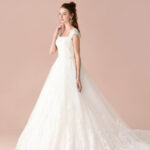 Princess wedding dress made of satin and organza with a straight neckline and sheer embellished straps
