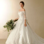 Princess wedding dress full of lace appliqués with a bateau neckline