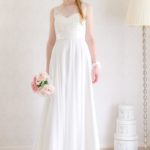 Slender line wedding dress that combines a simple dress with a trendy neckline the satin ribbon transforms it into an antique style dress