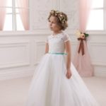 Beautiful little girl's formal dress made in satin and tulle with a bodice decorated with lace appliqués