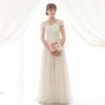 Beautiful simple wedding dress perfect for a civil wedding in chiffon with short sleeves decorated with fabric flowers.