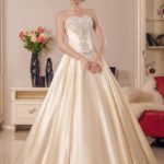 A line style golden wedding dress with a straight neckline embellished with sequins and sparkling stones