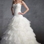 A-line wedding dress crafted in organza and satin, low-rise sweetheart neckline bodice featuring horizontal drapes and pearl, lace and sequin embellishments