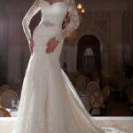Italian wedding dresses, sensual and elegant for sale online, mermaid style dress with transparent long sleeves for winter wedding at a low price