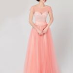 A line style salmon color cocktail dress made of tulle with satin lining, features a fabric band at the draped waist