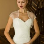 Short-sleeved semitransparent tulle wedding jacket with many shiny decorations on the edges
