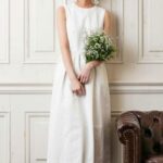 Very simple and delicate vintage 60s wedding dress made in satin with straps, back decorated with semi-sheer lace