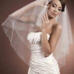 Beautiful short two-layer bridal veil in soft tulle decorated on the edges with beads