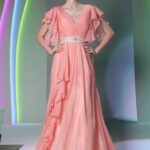 Elegant powder pink dress for a wedding guest with long skirt made of chiffon with butterfly sleeves