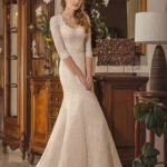 Elegant and romantic lace mermaid wedding dress with three-quarter sleeves, v-neckline and belt decorated with rhinestones and beads
