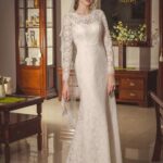 Refined and very elegant mermaid-style wedding dress made of lace with long sleeves and sheer back