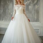 Princess wedding dress with long lace sleeves, stiff semi-sheer bodice, padded cups