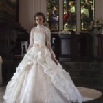 Very refined princess style wedding dress while the lace and rhinestone bodice and the high neckline give the dress a note of classic style