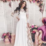 An exquisite fit and flare wedding dress in rich embroidered tulle and chiffon with long sleeves