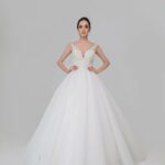 Wedding dress made with the highest quality materials and refined in every detail, silhouette outlined by a plunging neckline
