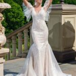 Sexy curvy wedding dress, a mermaid model in lace with transparencies, impressive pronounced neckline topped with straps