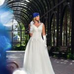 Plus size wedding dress that exudes pure sweetness with a lace bodice that opens into a plunging neckline and an open back framed by straps